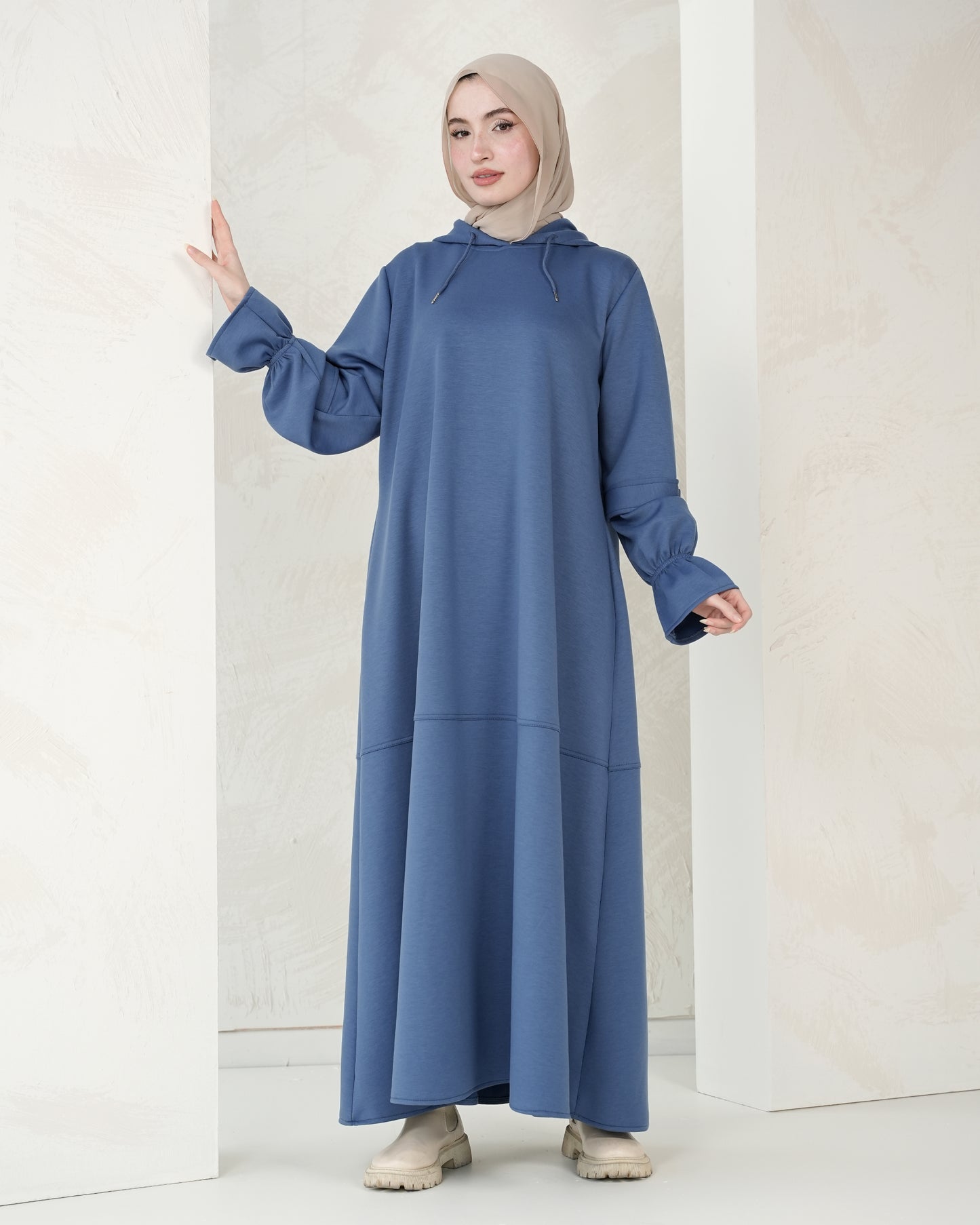 The dress features a comfortable, loose-fitting silhouette that flatters all body types, with delicately detailed sleeves adding a refined feminine touch