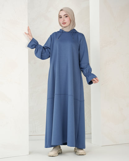 The dress features a comfortable, loose-fitting silhouette that flatters all body types, with delicately detailed sleeves adding a refined feminine touch