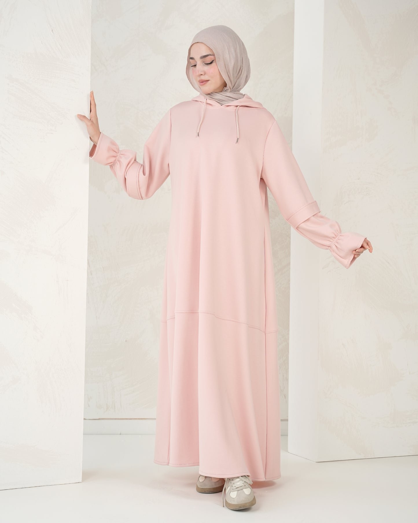 The dress features a comfortable, loose-fitting silhouette that flatters all body types, with delicately detailed sleeves adding a refined feminine touch
