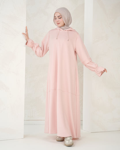The dress features a comfortable, loose-fitting silhouette that flatters all body types, with delicately detailed sleeves adding a refined feminine touch