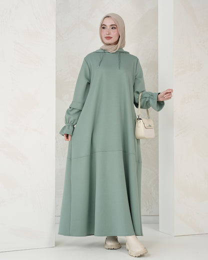 The dress features a comfortable, loose-fitting silhouette that flatters all body types, with delicately detailed sleeves adding a refined feminine touch