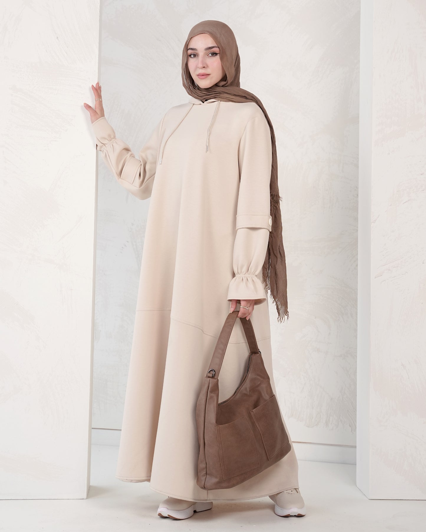 The dress features a comfortable, loose-fitting silhouette that flatters all body types, with delicately detailed sleeves adding a refined feminine touch