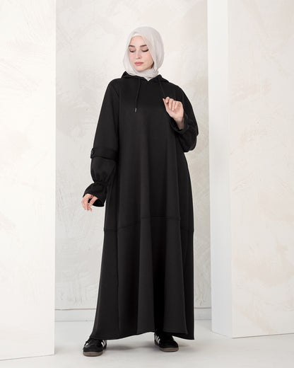 The dress features a comfortable, loose-fitting silhouette that flatters all body types, with delicately detailed sleeves adding a refined feminine touch